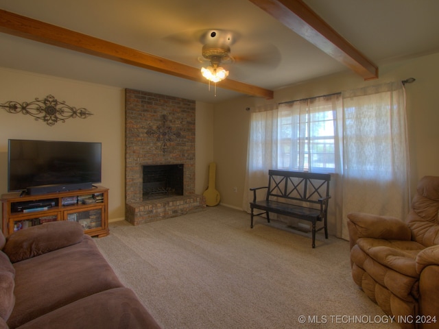 carpeted living room featuring a fireplace, beam ceiling, and ceiling fan