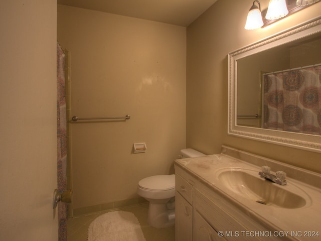 bathroom with tile patterned floors, vanity, and toilet