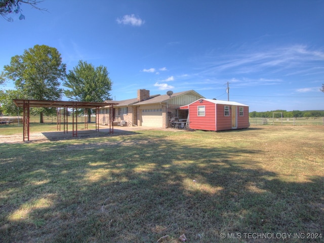 view of yard with a garage and an outdoor structure