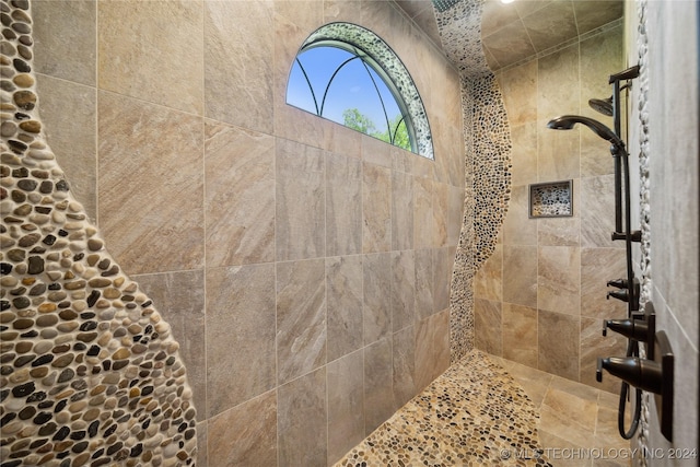 bathroom with tiled shower