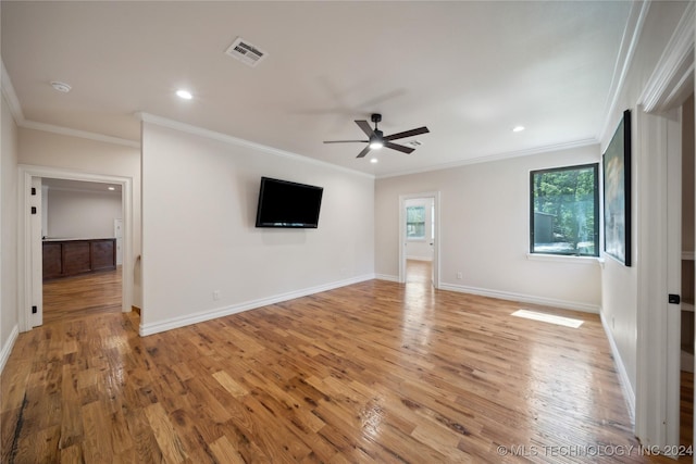 empty room featuring ceiling fan, ornamental molding, and light hardwood / wood-style flooring