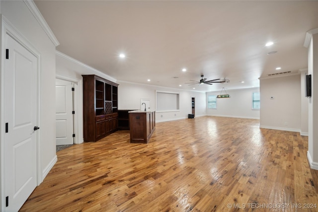 unfurnished living room with ceiling fan, crown molding, and light hardwood / wood-style floors