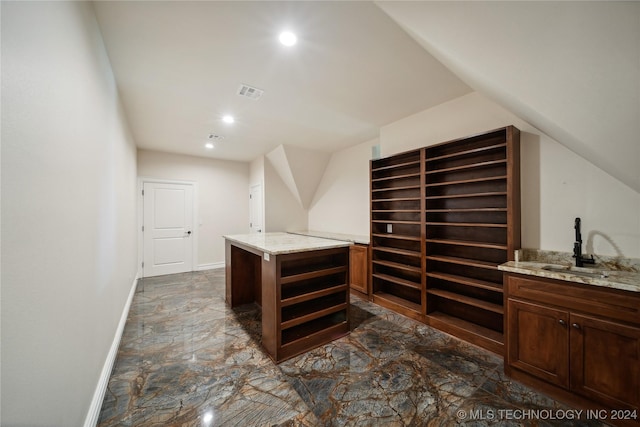 bar with light stone counters and sink