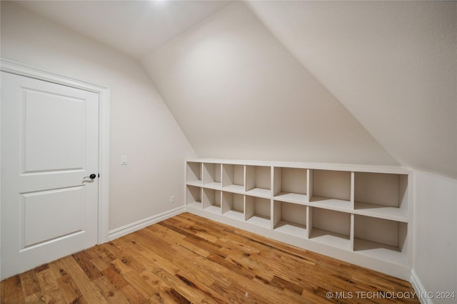 bonus room with lofted ceiling and hardwood / wood-style floors