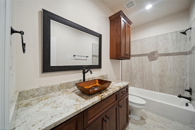 full bathroom with toilet, tiled shower / bath, and vanity