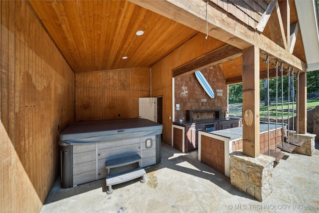 view of patio / terrace featuring a hot tub and exterior kitchen