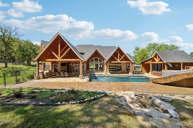 view of swimming pool featuring a fireplace, an outdoor structure, and a patio