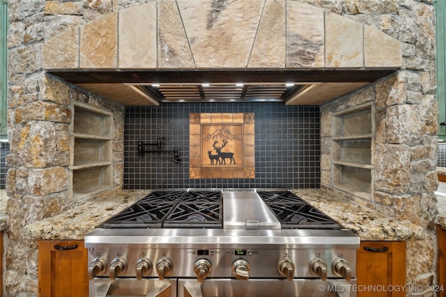 kitchen featuring decorative backsplash, range, and beamed ceiling