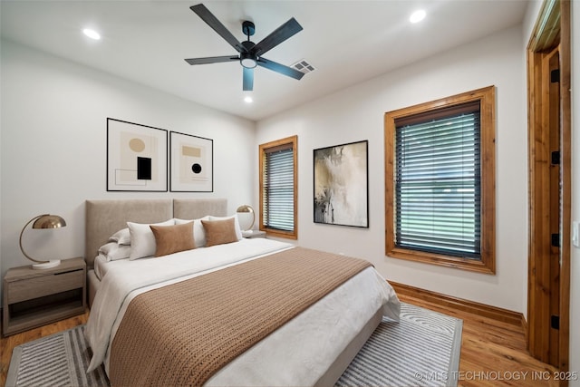 bedroom with ceiling fan and light hardwood / wood-style floors