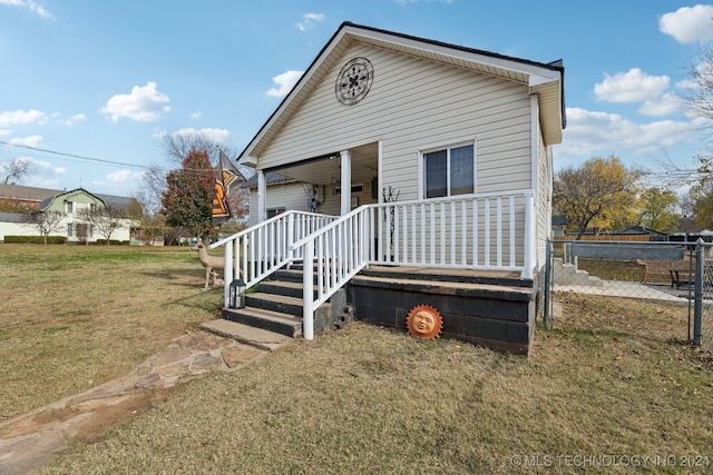 view of front of house featuring a front yard and covered porch