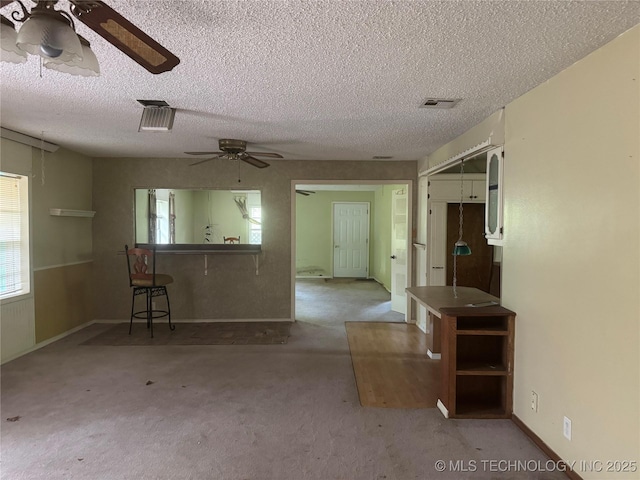 26385 State Highway 1 E, Allen, OK 74825 - carpeted spare room with ceiling fan and a textured ceiling
