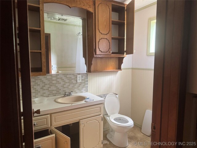 26385 State Highway 1 E, Allen, OK 74825 - bathroom featuring toilet, vanity, tasteful backsplash, and tile patterned floors