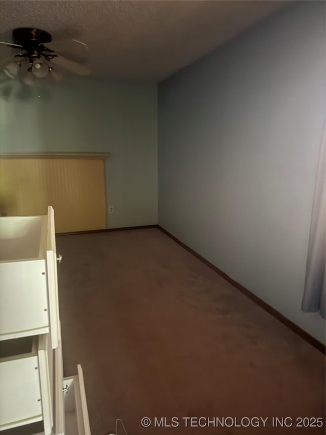 26385 State Highway 1 E, Allen, OK 74825 - carpeted spare room with a ceiling fan, baseboards, and a textured ceiling