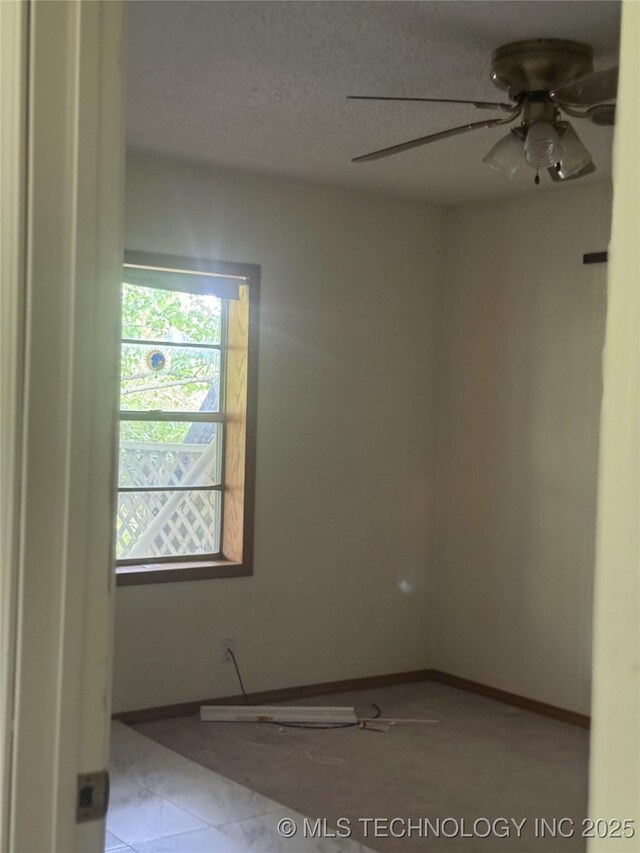 26385 State Highway 1 E, Allen, OK 74825 - unfurnished room featuring a ceiling fan, baseboards, and a textured ceiling