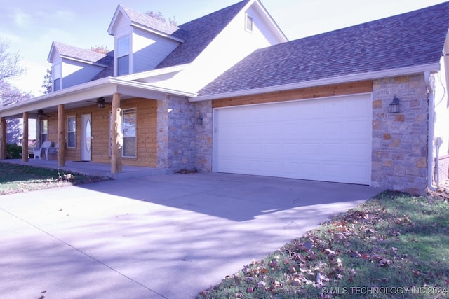 view of front of property with a porch and a garage