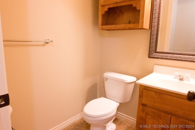 bathroom featuring tile patterned flooring, vanity, and toilet