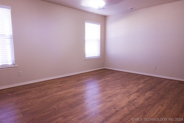 empty room featuring dark hardwood / wood-style flooring