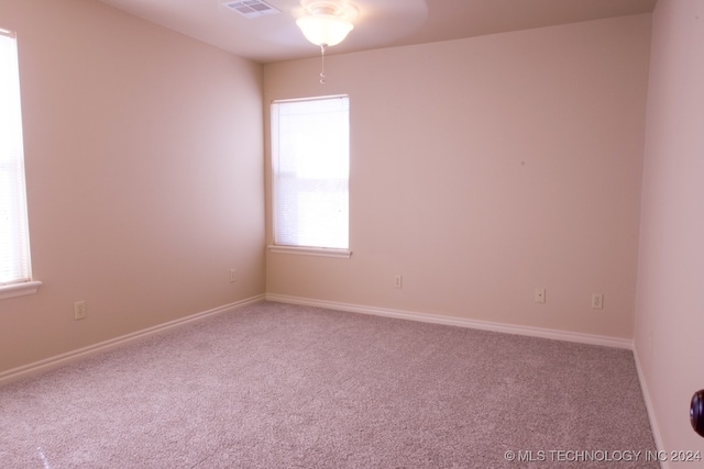 empty room featuring carpet flooring and ceiling fan