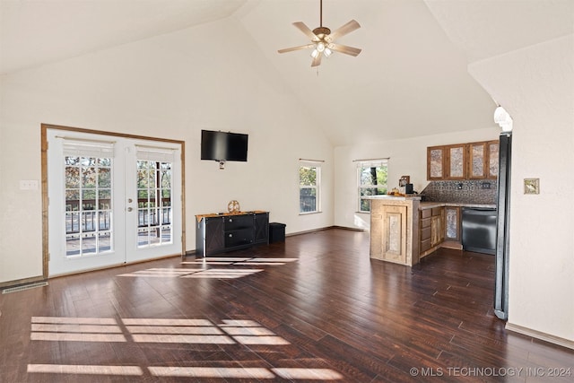 unfurnished living room with ceiling fan, dark hardwood / wood-style flooring, and high vaulted ceiling