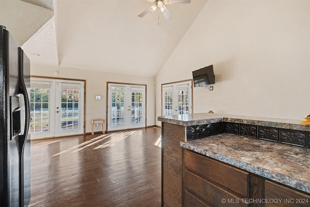 kitchen with ceiling fan, french doors, black refrigerator with ice dispenser, high vaulted ceiling, and dark hardwood / wood-style floors