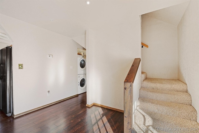 interior space with stacked washer / dryer and hardwood / wood-style flooring