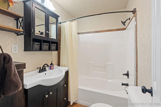 bathroom featuring vanity, shower / bath combo, and a textured ceiling