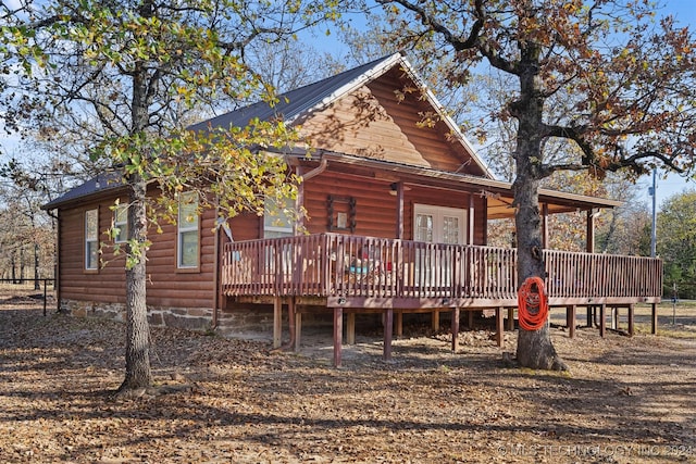 rear view of house featuring a wooden deck