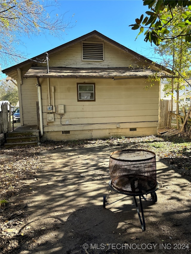 back of property featuring a fire pit