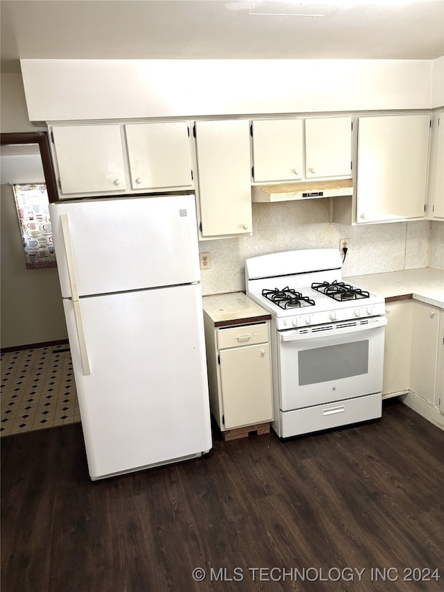 kitchen featuring dark hardwood / wood-style flooring, white appliances, and tasteful backsplash