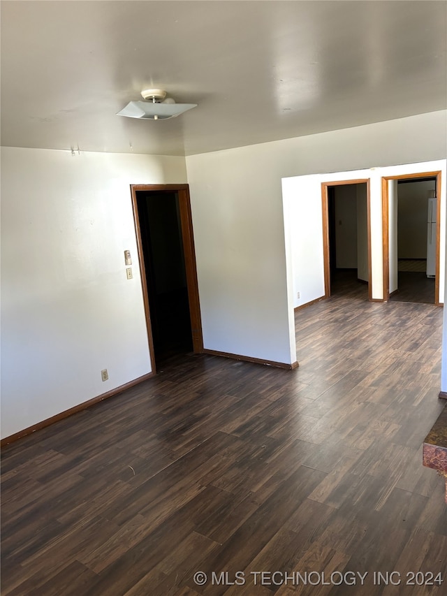 unfurnished room with dark hardwood / wood-style floors