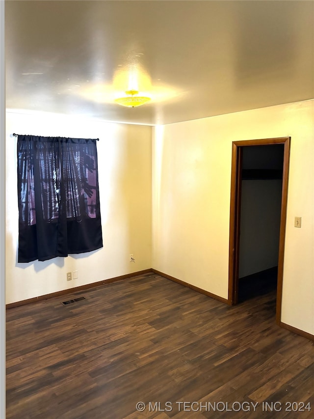 unfurnished room with dark hardwood / wood-style floors