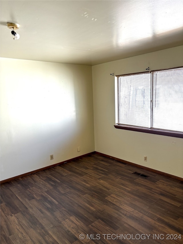 empty room featuring dark hardwood / wood-style flooring