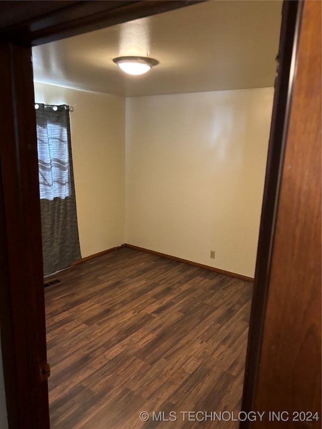 empty room with dark hardwood / wood-style floors