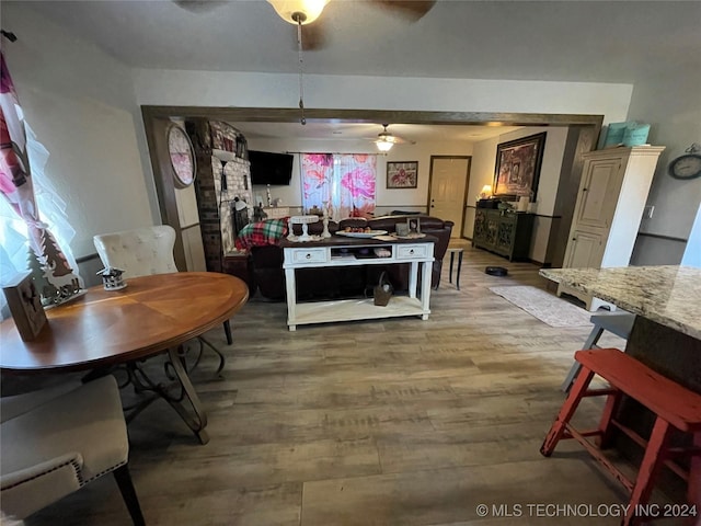 dining space with wood-type flooring and ceiling fan