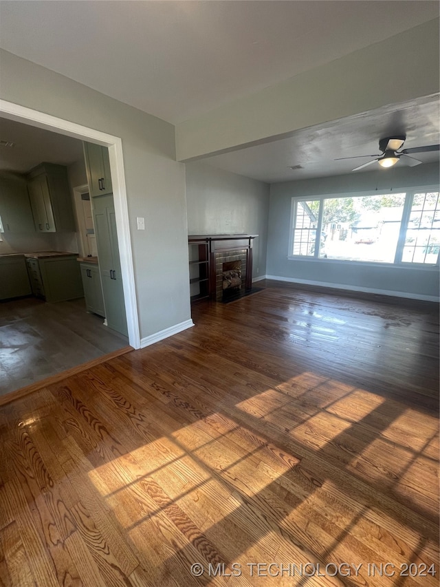 unfurnished living room with hardwood / wood-style floors and ceiling fan