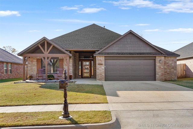 craftsman-style home featuring a front yard, a porch, and a garage