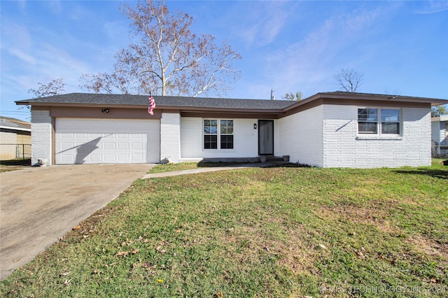 single story home with a garage and a front lawn