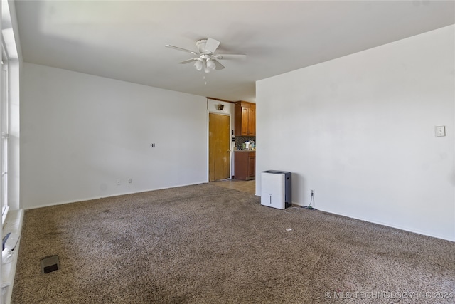 carpeted empty room with ceiling fan