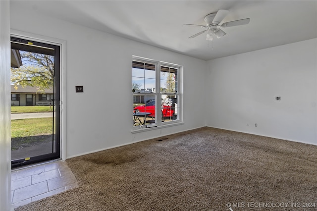 unfurnished room featuring carpet flooring, plenty of natural light, and ceiling fan