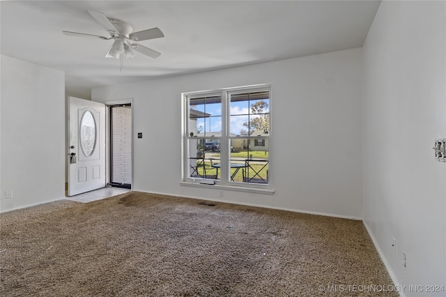 unfurnished room with ceiling fan and light carpet