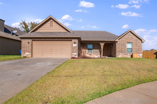 ranch-style home with a garage and a front lawn