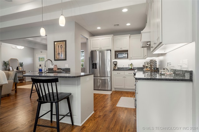 kitchen featuring white cabinetry, dark wood-type flooring, beamed ceiling, and stainless steel appliances