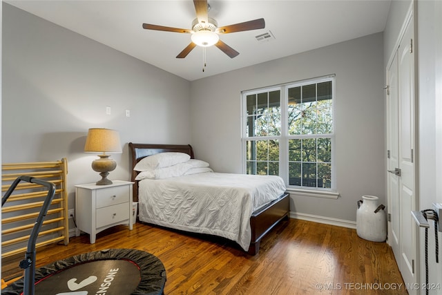 bedroom featuring dark hardwood / wood-style floors and ceiling fan