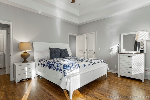 bedroom featuring dark hardwood / wood-style flooring, a closet, and ceiling fan