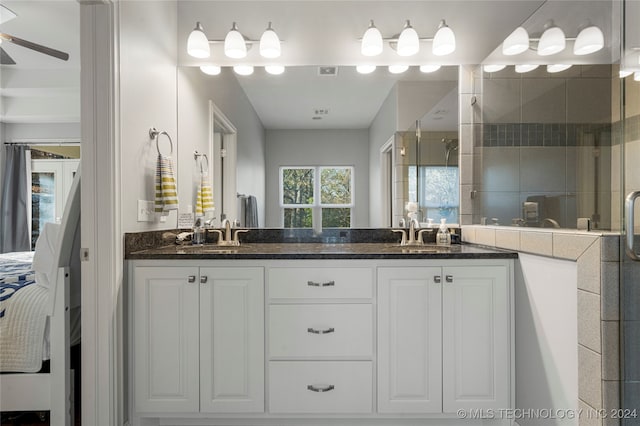 bathroom with ceiling fan, an enclosed shower, and vanity