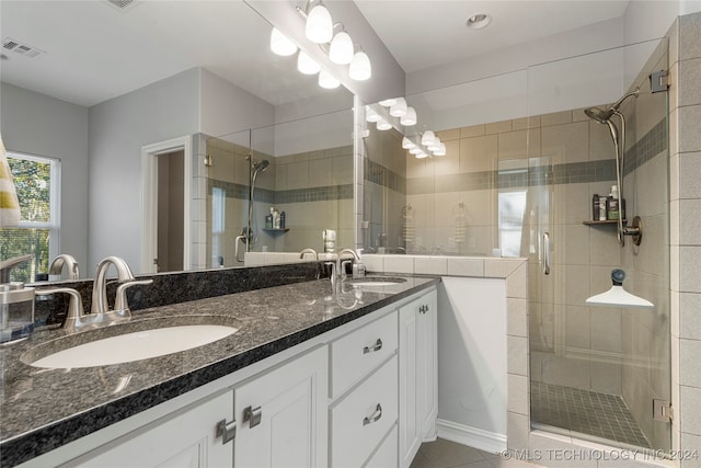 bathroom featuring tile patterned floors, vanity, and an enclosed shower