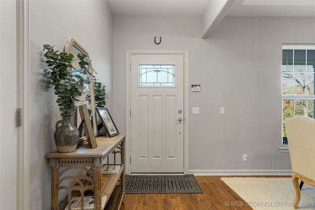 foyer with beamed ceiling and hardwood / wood-style flooring