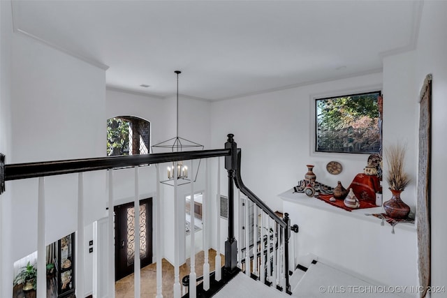 stairway with an inviting chandelier