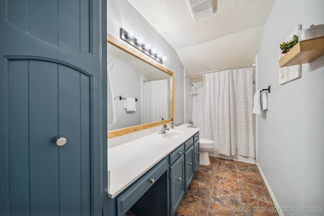 bathroom featuring vanity, toilet, a textured ceiling, and lofted ceiling