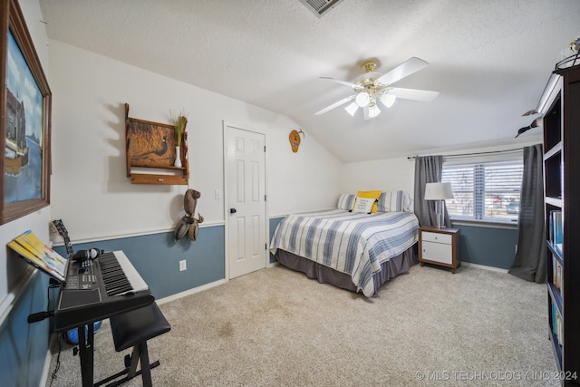 bedroom featuring ceiling fan, a textured ceiling, light carpet, and lofted ceiling